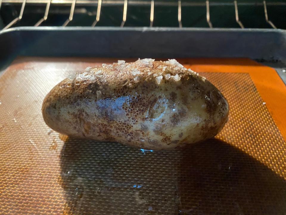 potato on a baking tray on an oven rack