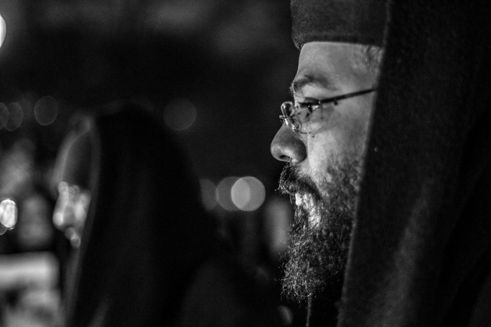 A Coptic priest leads a prayer for the souls of martyrs.