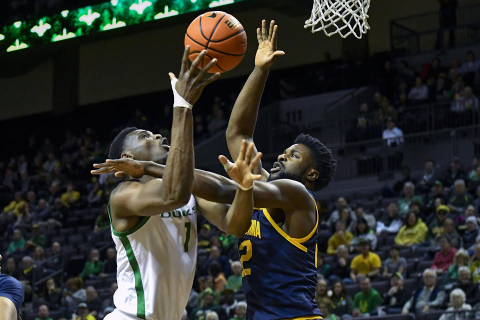 Oregon center N'Faly Dante (1) is defended by California forward ND Okafor (22) during the first half of an NCAA college basketball game Thursday, March 2, 2023, in Eugene, Ore. (AP Photo/Andy Nelson)