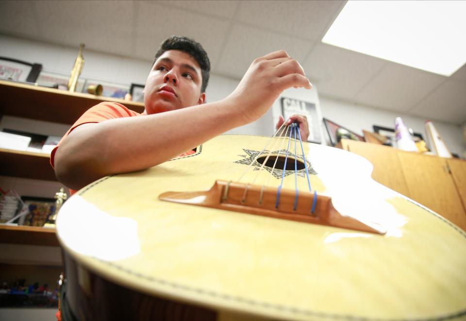 Denison High School junior Adrain Velazquez-Nieto practices his guitarron.