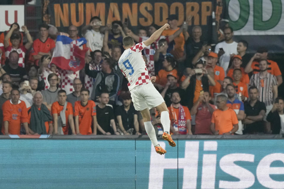 Croatia's Andrej Kramaric celebrates after scoring his side's first goal from the penalty spot during the Nations League semifinal soccer match between the Netherlands and Croatia at De Kuip stadium in Rotterdam, Netherlands, Wednesday, June 14, 2023. (AP Photo/Peter Dejong)