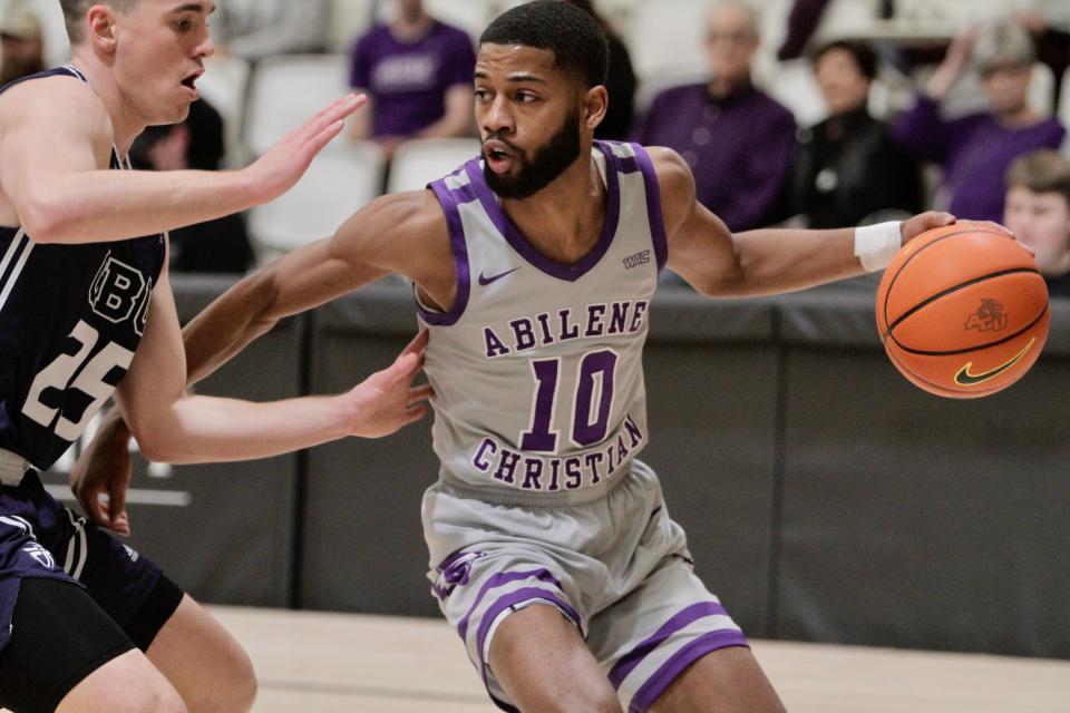 ACU senior Reggie Miller dribbles on the outside agianst Cal Baptist's Ty Rowell.