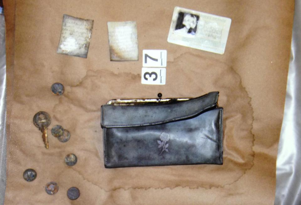 In this undated photo provided by the South Dakota Attorney Generals Office, Cheryl Miller's driver's license, purse and other belongings are seen. Two South Dakota girls on their way to an end-of-school-year party at a gravel pit in May 1971 drove off a country road into a creek and remained hidden until last fall when a drought brought their car into view, authorities said Tuesday, April 15, 2014. State and local officials held a news conference Tuesday afternoon confirming that the 1960 Studebaker unearthed in September included the remains of Cheryl Miller and Pamella Jackson, both 17-year-olds who attended Vermillion High School. (AP Photo/South Dakota Attorney Generals Office)