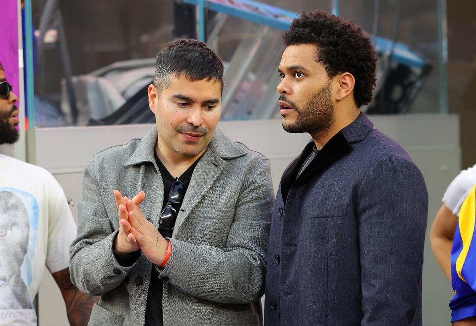 Two men standing at a football game.