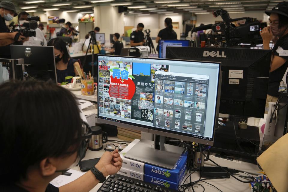Staff members design their layout for the last edition of newspaper in the Apple Daily headquarters in Hong Kong, Wednesday, June 23, 2021. Hong Kong's pro-democracy Apple Daily newspaper will stop publishing Thursday, following last week's arrest of five editors and executives and the freezing of $2.3 million in assets under the city's year-old national security law. (AP Photo/Kin Cheung)