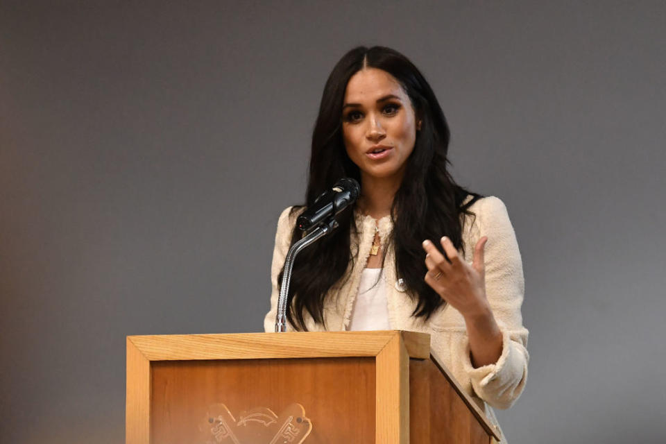 The Duchess fo Sussex wearing the Edge of Ember "Kismet" charm necklace.  (Photo by BEN STANSALL / POOL / AFP) 