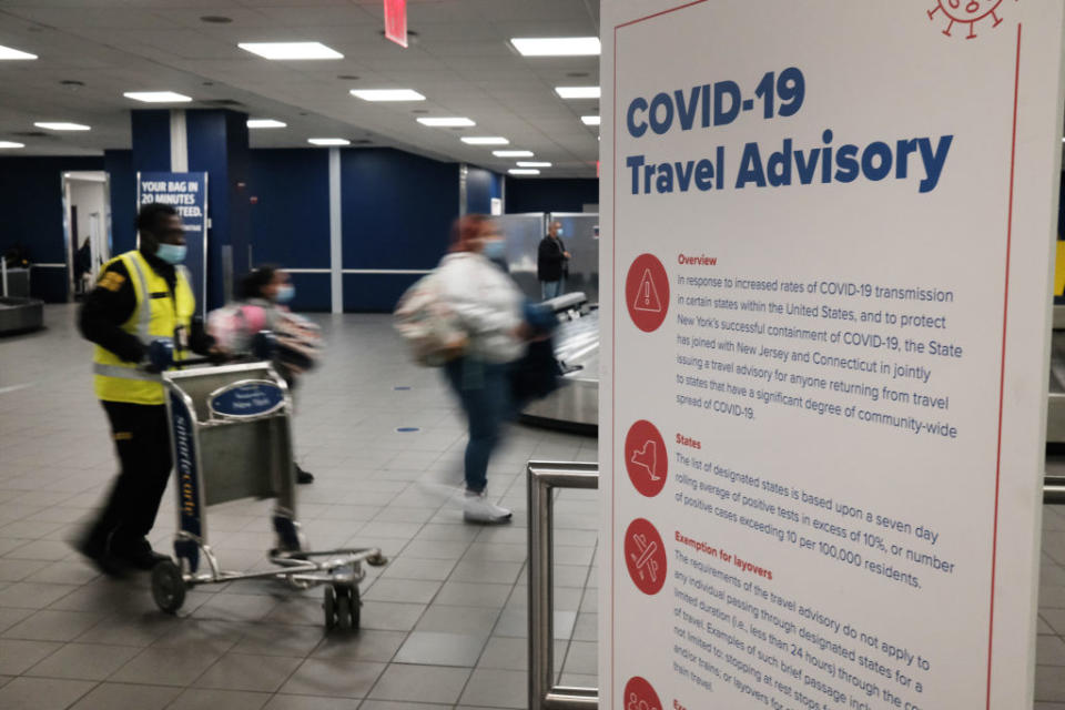 Signs warn travelers of COVID-19 in New York’s LaGuardia Airport in New York City. (Photo by Spencer Platt/Getty Images)