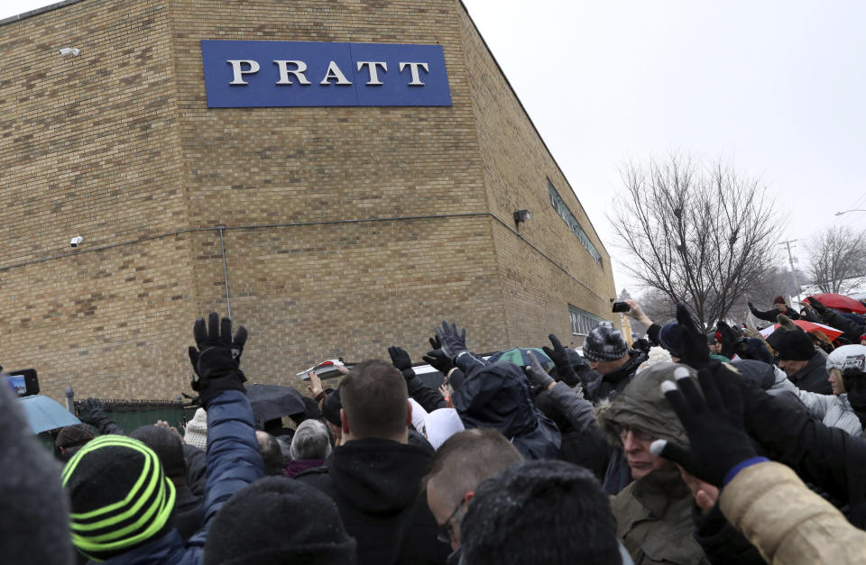 Family, friends and community members attend a vigil Sunday, Feb. 17, 2019, in Aurora, Ill. Six people, including a gunman, died in a shooting at a manufacturing warehouse in Aurora on Friday afternoon, and five officers were struck by gunfire. (AP Photo/Nam Y. Huh)