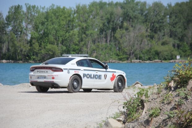 Windsor police cruiser is parked in the area where two international students went missing at Sandpoint Beach.