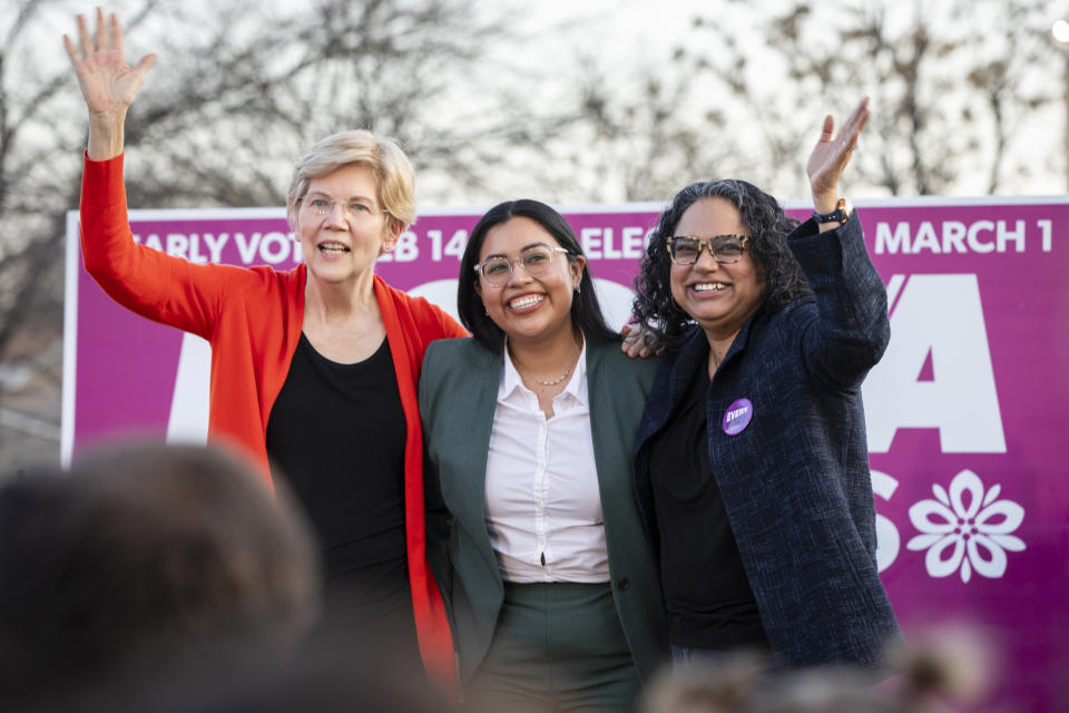 Senator Elizabeth Warren, Jessica Cisneros and Mini Timmaraju smile and wave.