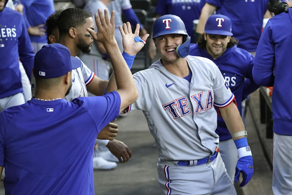 Texas Rangers' Josh Jung, right, celebrates in the dugout his home run off Chicago White Sox starting pitcher Tanner Banks during the third inning of a baseball game Monday, June 19, 2023, in Chicago. (AP Photo/Charles Rex Arbogast)