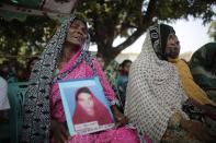 Relatives of garment workers, who went missing in the Rana Plaza collapse, mourn as they wait for a mass prayer on the first year anniversary of the accident, at a school in Savar April 24, 2014. Protesters and family members of victims demand compensation on the one year anniversary of the collapse of Rana Plaza, in which more than 1,100 factory workers were killed and 2,500 others were injured.