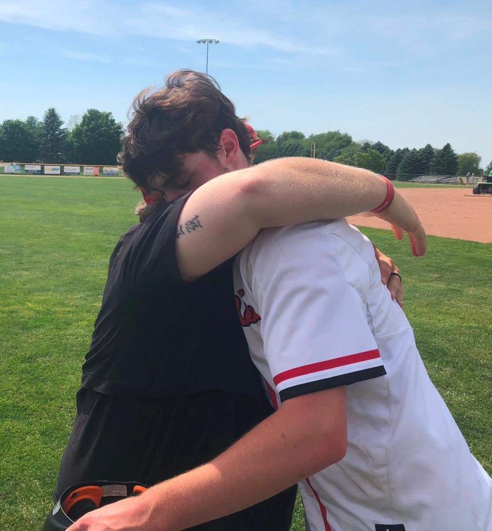 Brimfield-Elmwood pitcher/first baseman Drew Bryant and head coach Brandon Porter embrace after the Indians lost 10-0 to Joliet Catholic in the IHSA Class 2A Geneseo Supersectional at Bollen Field on Monday, May 30, 2022.