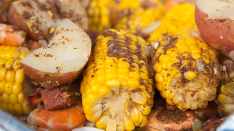 Seasoned corn cobs, potato, sausage, and shrimp