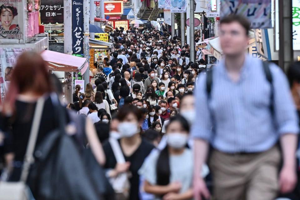 People walk down Takeshita Street in the popular Harajuku area of Tokyo (AFP via Getty Images)