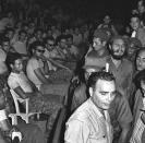 Fidel Castro (3rd row, R) enters a public trial for captured members (seated) of the failed Bay of Pigs invasion in Havana in April 1961. REUTERS/Prensa Latina