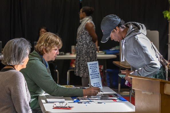 CHARLOTTE, NORTH CAROLINA - MARCH 5: Poll workers assist voters on Super Tuesday at the First Ward Creative Academy, Mecklenburg County Precinct 13 on March 5, 2024 in Charlotte, North Carolina. 15 States and one U.S. Territory hold their primary elections on Super Tuesday, awarding more delegates than any other day in the presidential nominating calendar.  (Photo by Grant Baldwin/Getty Images)