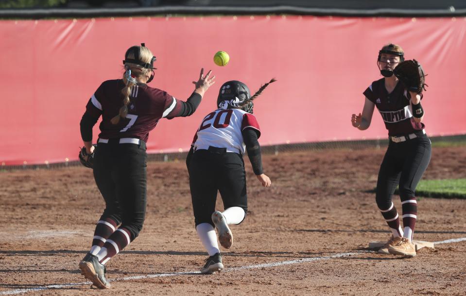 Ballard’s Macy McCoy (20) beat the rundown back to third against Assumption at Ballard High School in Louisville, Ky. on May 5, 2021.  Ballard won 5-0.