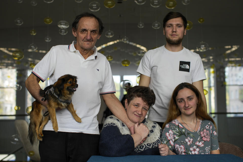 Serhii Tsybulchenko, Elina Tsybulchenko, Ihor Trotsak and Tetyana Trotsak, from left, who fled from Azovstal steel plant in Mariupol, pose for a family photo in Zaporizhzhia, Ukraine, Wednesday, May 4, 2022. The family was among the first to emerge from the steel plant in a tense, days-long evacuation negotiated by the United Nations and the International Committee of the Red Cross with the governments of Russia, which now controls Mariupol, and Ukraine, which wants the city back. A brief cease-fire allowed more than 100 civilians to flee the plant. (AP Photo/Francisco Seco)