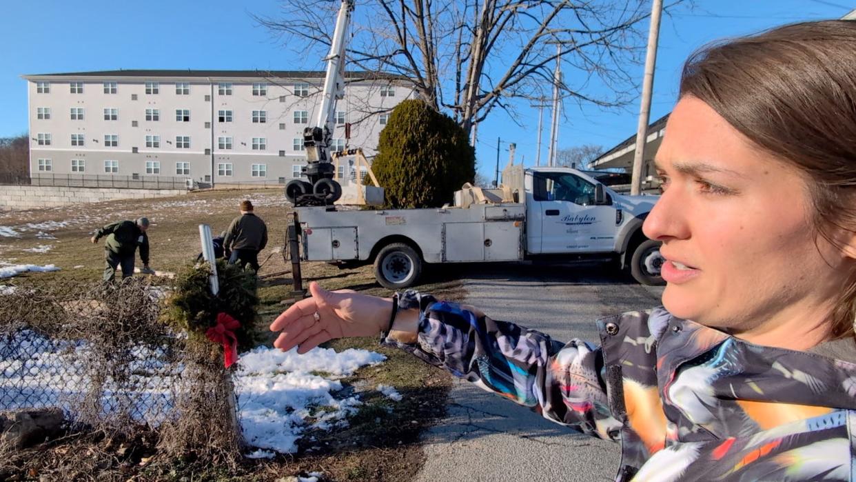 Jamie Noerpel talks about York City Cemetery while the monument is placed in February 14, 2024. She pondered the potterÕs field from her desk inside her apartment, in the background. And then decided to start a fundraising campaign to recognize the 800 who were buried there without grave markers.