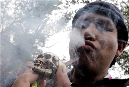 A man smokes a joint during a rally for the legalization of marijuana Mexico City in this September 5, 2010 file photo. REUTERS/Henry Romero/Files