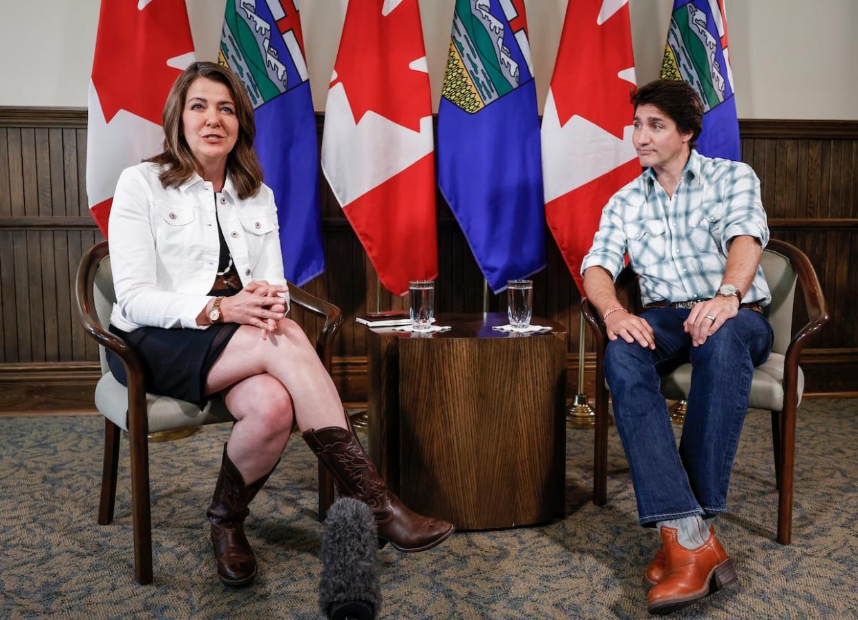 Prime Minister Justin Trudeau, right, has fired back in opposition to Alberta Premier Danielle Smith on her proposed Canada Pension Plan withdrawal. They exchanged open letters, having not met in person since the Calgary Stampede in July. (Jeff McIntosh/The Canadian Press - image credit)