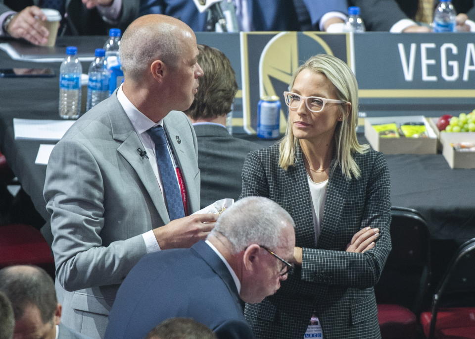 FILE - Vancouver Canucks hockey team assistant general manager Emilie Castonguay talks to general manager Patrik Allvin during the first round of the NHL draft in Montreal, Thursday, July 7, 2022. At the start of 2022, there were no women serving as assistant general managers in the NHL. Now there are five. (Graham Hughes/The Canadian Press via AP, File)