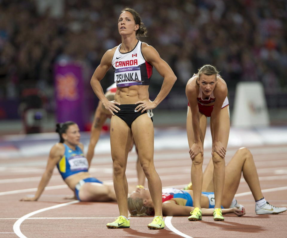 Canada's Jessica Zelinka looks at her results of the 800-metre event of the women's heptathlon after finishing in seventh place. (THE CANADIAN PRESS/Ryan Remiorz)