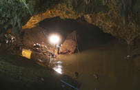 <p>Thai rescuers work at the entrance to a cave where 12 boys and their soccer coach have been missing in Mae Sai, Chiang Rai Province, in northern Thailand, June 29, 2018. Rescuers punched a hole into the side of a mountain on Thursday in a desperate attempt to drain rising water from the flooded cave. (Photo: Sakchai Lalit/AP) </p>