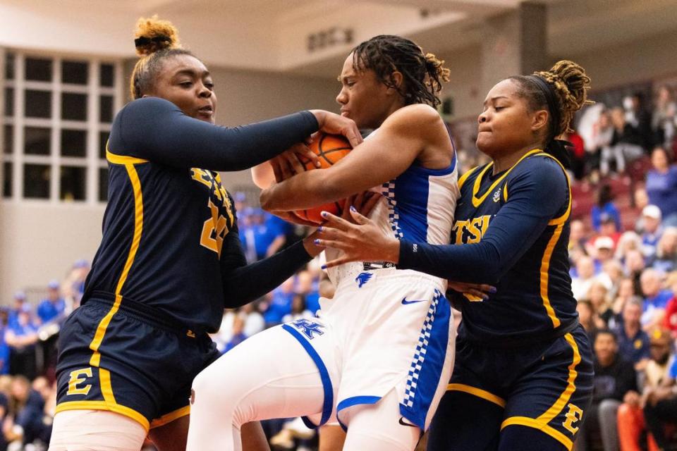 Kentucky’s Ajae Petty fights two ETSU players for possession Tuesday night. Petty finished with 12 points and a game-high 13 rebounds.