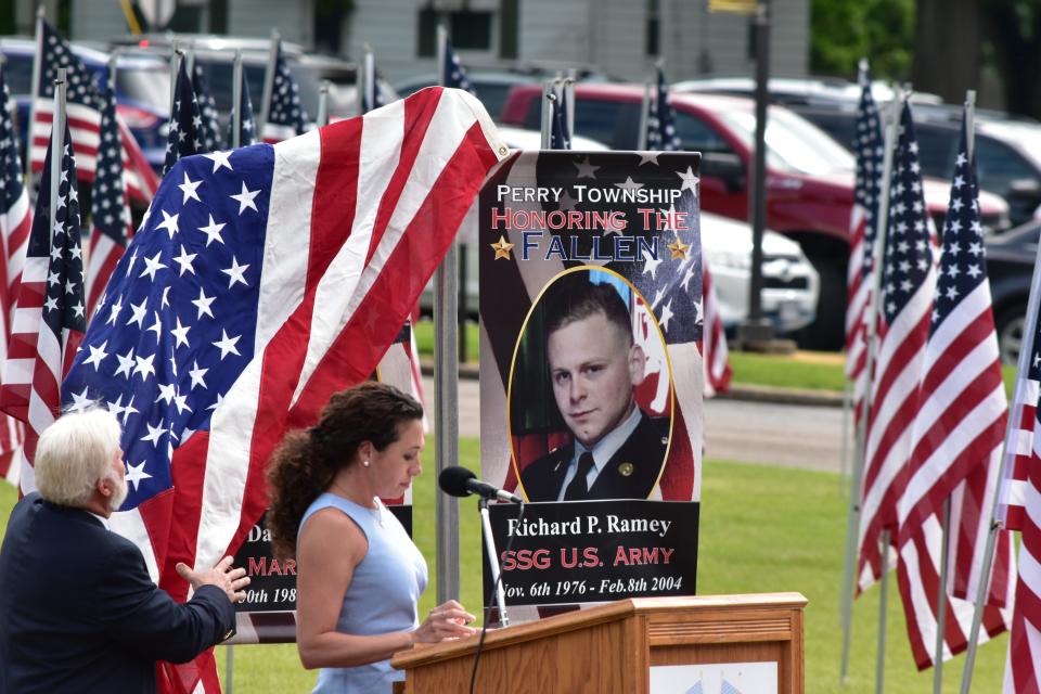 Ashley Escola and Steve Toohey unveil the Streets of Honor Project on Saturday at the Heroes Remembrance Ceremony.