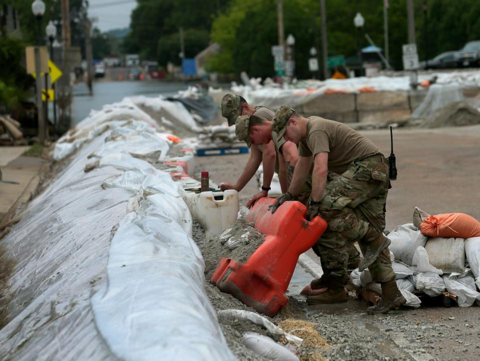 Members of the 233rd Military Police out of Springfield, Illinois, take down the most eastern portion of the flood wall along Main Street on Wednesday, June 19, 2019, in Grafton. On Wednesday, the level of the Mississippi River was 30.2 feet, having dropped about five feet from its crest at 35.17 on June 7. (Photo: Laurie Skrivan/St. Louis Post-Dispatch via AP)