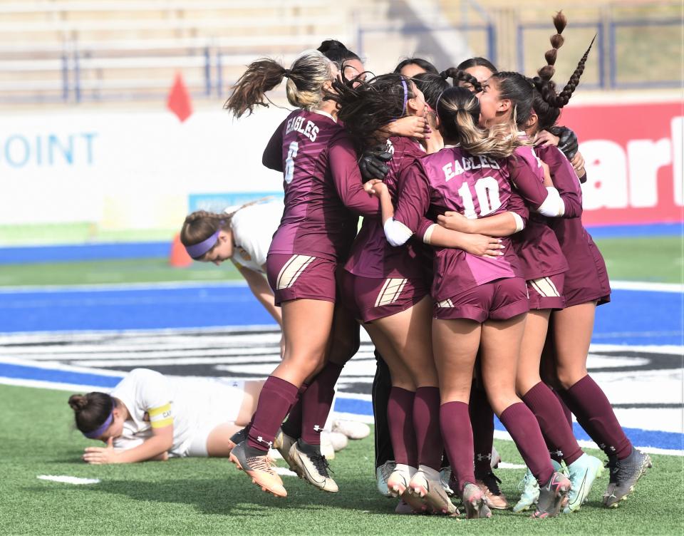 El Paso Andress players celebrate their 5-4 overtime victory as two Wylie players deal with the loss. Andress scored twice in overtime to overcome the Lady Bulldogs in the Region I-5A area playoff game Monday, March 27, 2023, at Astound Broadband Stadium in Midland.