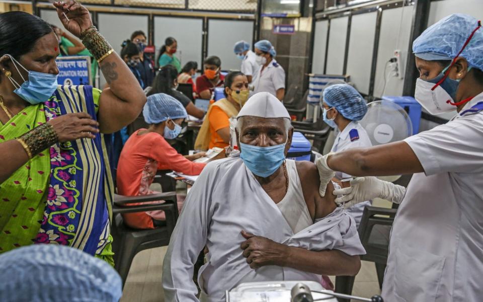 A man receives a shot of Covid-19 vaccine inside a vaccination centre at Shatabdi Hospital in Mumbai, India - DIVYAKANT SOLANKI/EPA-EFE/Shutterstock