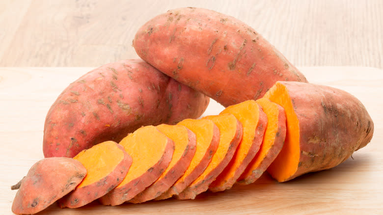 Sliced sweet potato on wood surface