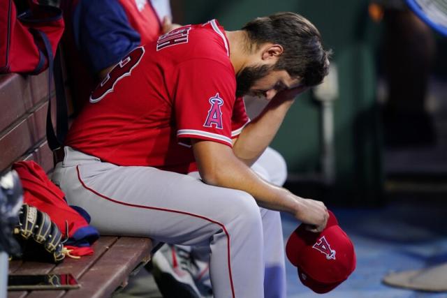 Los Angeles Angels pitcher Jaime Barria, right, sits in the dugout