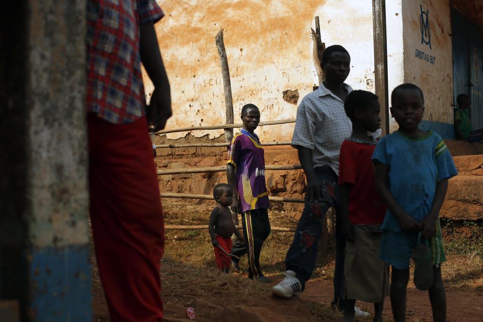 Muslim men and children hang out by the market in the Seleka controlled town of Mbaiki, some 120kms (75 miles) south west of bangui, Central African Republic, Sunday Jan. 26, 2014. A local commander of the Muslim Seleka blamed Christian anti Balaka militias for sending the country into chaos and vowed reprisals if the newly appointed interim government would not put an end to Muslim killings in the country. (AP Photo/Jerome Delay)