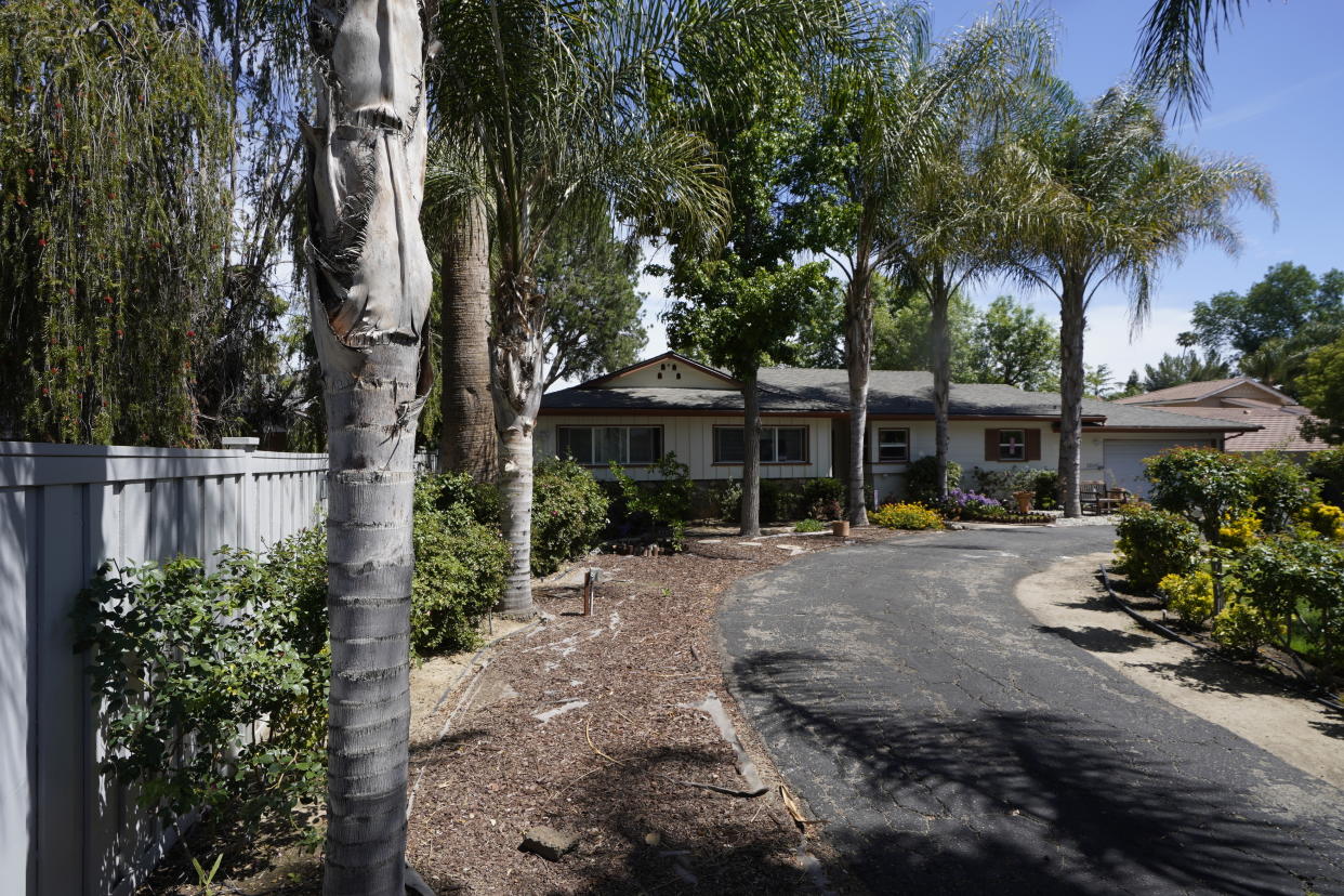A ranch-style house in the West Hills neighborhood of the San Fernando Valley is seen in Los Angeles, Monday, May 9, 2022. Police say three children were found dead at this Los Angeles home over the weekend and their mother and a teenager were arrested in the killings. (AP Photo/Damian Dovarganes)
