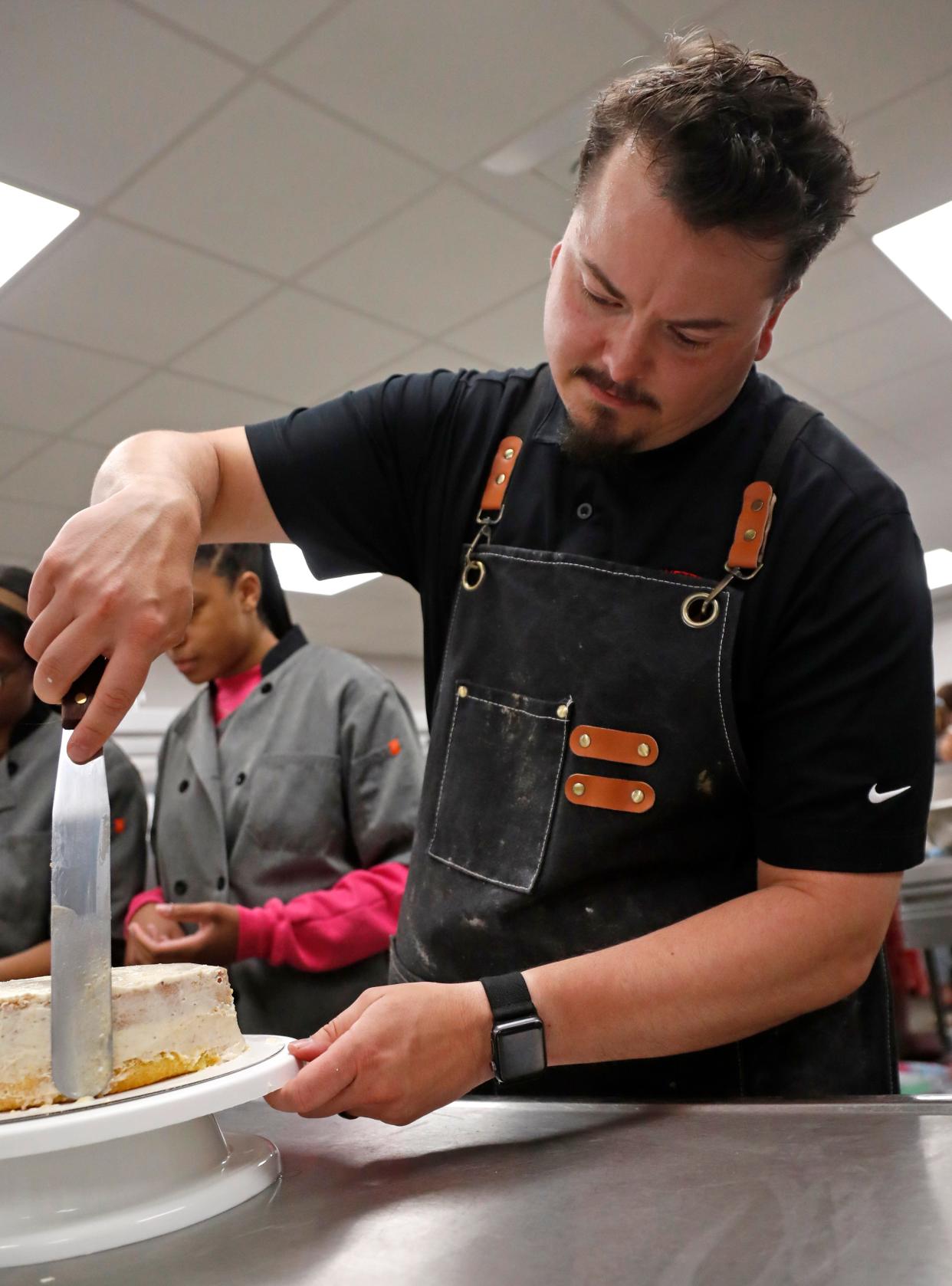 SJ Houston leads his class on a lesson in cake icing, Tuesday, April 16, 2024, at Lafayette Jeff High School in Lafayette, Ind.