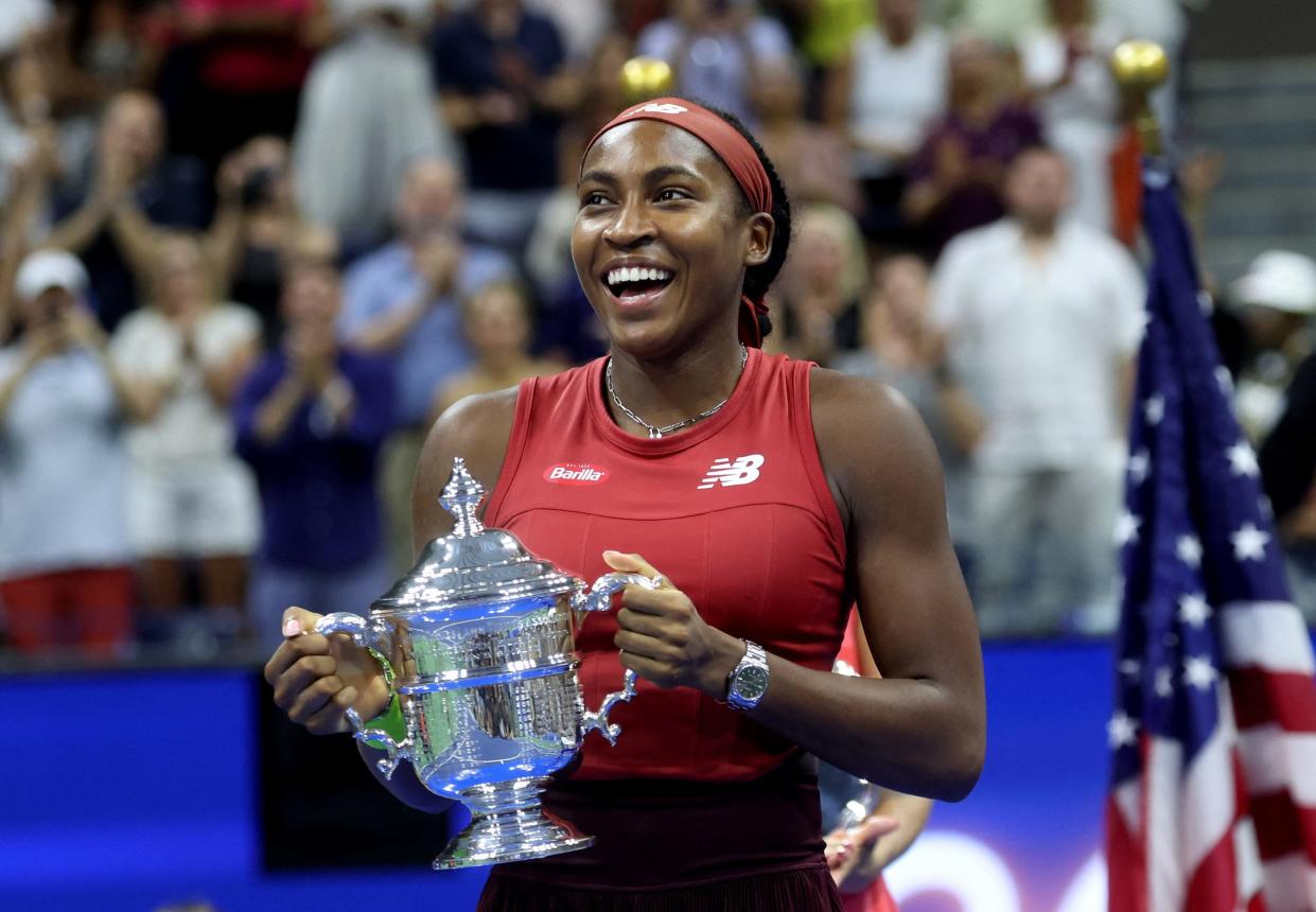 Coco Gauff poses with her trophy after winning the 2023 US Open.