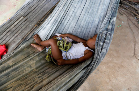 A kid sleeps in a hammock at a traditional Cambodian medicine shop in Kampong Speu, Cambodia, July 4, 2018. REUTESR/Ann Wang