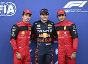 Red Bull driver Max Verstappen of the Netherlands, center, poses with \second placed Ferrari driver Charles Leclerc of Monaco, left, and third placed Ferrari driver Carlos Sainz of Spain after he clocked the fastest time during the qualifying session at the Red Bull Ring racetrack in Spielberg, Austria, Friday, July 8, 2022. The Austrian F1 Grand Prix will be held on Sunday July 10, 2022. (Christian Bruna/Pool via AP)