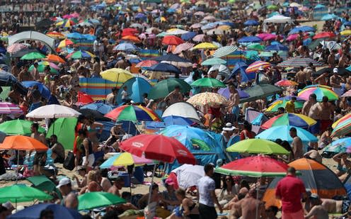 <span class="caption">Crowds gather on a Bournemouth beach on June 25 2020 – the hottest day of the year so far.</span> <span class="attribution"><a class="link " href="https://paimages.co.uk/image-details/2.54302676" rel="nofollow noopener" target="_blank" data-ylk="slk:Andrew Matthews/PA;elm:context_link;itc:0;sec:content-canvas">Andrew Matthews/PA</a></span>