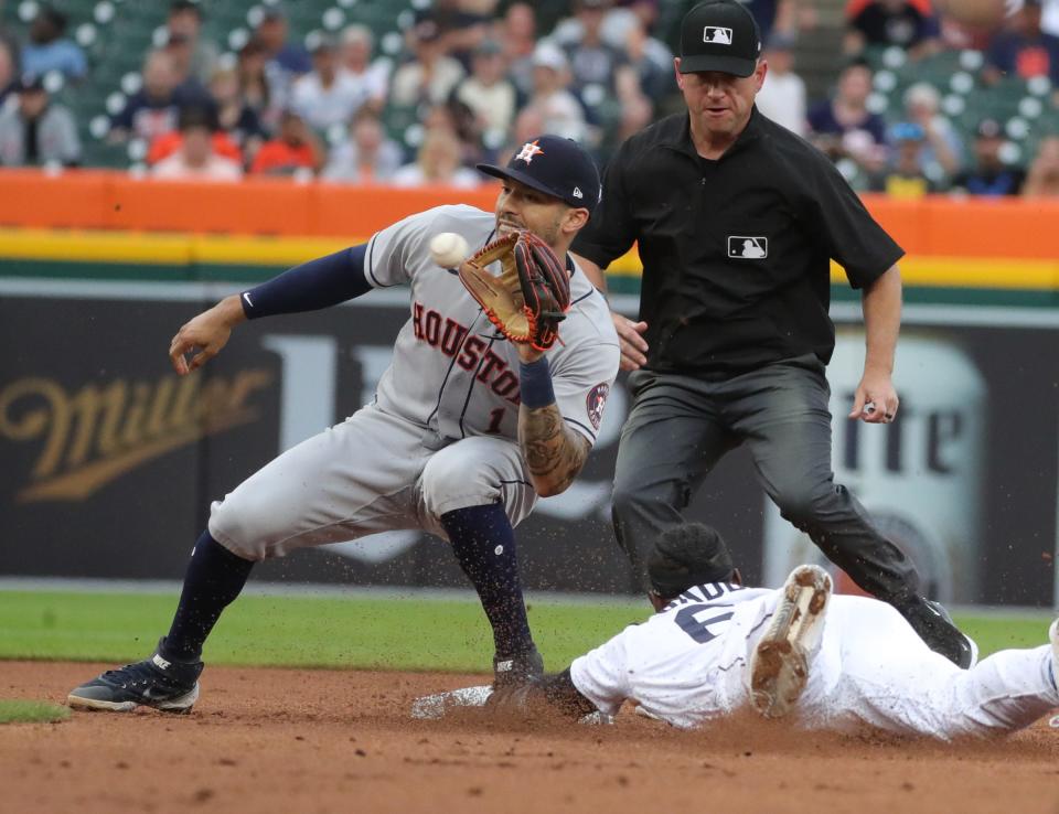 Detroit Tigers center fielder Akil Baddoo (60) is tagged out on a steal attempt by Houston Astros shortstop Carlos Correa (1) during first inning action on Thursday, June 24, 2021, at Comerica Park in Detroit.