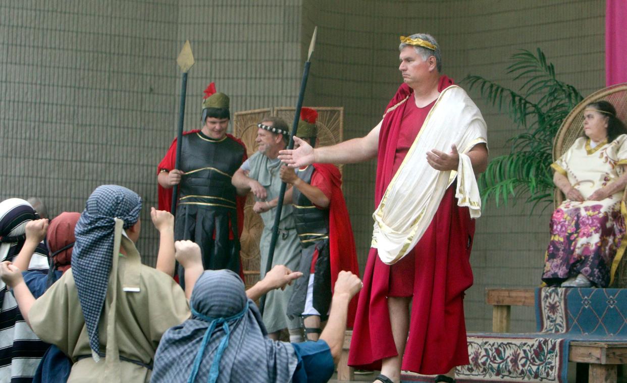 Randy Kolanda (as Pontius Pilot), center, faces an angry mob that demands a condemned criminal Barabbas (Bobby Fellows - left) be set free and Jesus instead should be crucified at Cole Park in Corpus Christi, Sunday, March 27, 2016. At far right is Cecilia Cashion as the wife of Pilot.