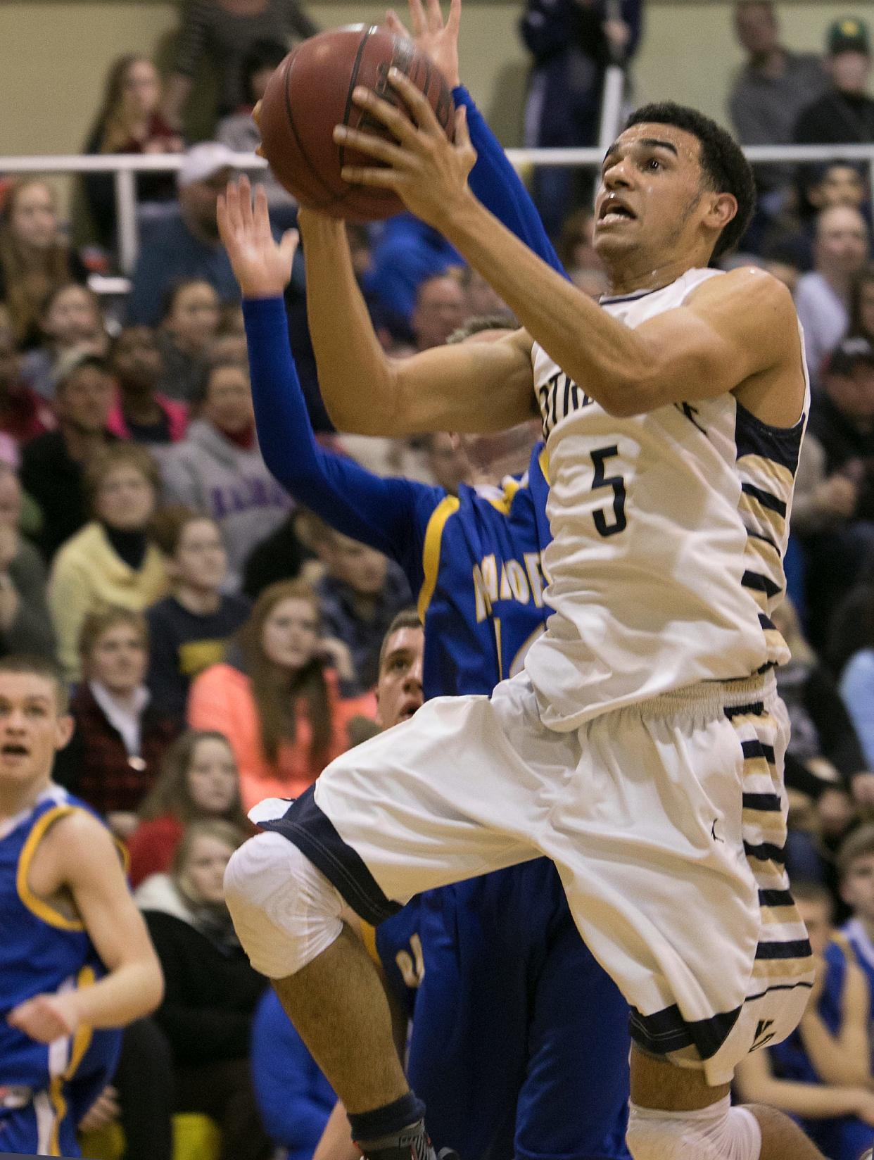 Senior point guard Darius Garvin, shown against Trumansburg in a sectional quarterfinal victory, averaged 24.9 points, 11 rebounds, 5 assists and 4.5 steals to lead the Crusaders to a 15-5 record.