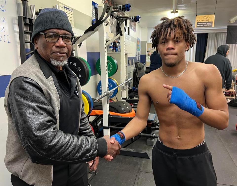 Lorenzo Scott, left, is shown with Cason Akins, a 14-year-old boxer from Massillon who trains at United Boxing Club in Canton. Scott is a longtime boxing trainer in Stark County who is being honored at The Brawl II on Saturday in Canton.