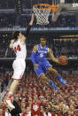 Kentucky guard Andrew Harrison, right, drives to the basket past Wisconsin forward Frank Kaminsky during the first half of the NCAA Final Four tournament college basketball semifinal game Saturday, April 5, 2014, in Arlington, Texas. (AP Photo/Eric Gay)