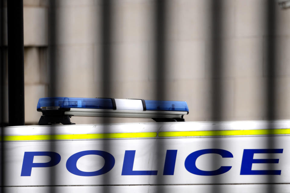 A police van is parked behind railings in Westminster in London, Tuesday, March 21, 2023. An independent review says London police have lost the confidence of the public because of deep-seated racism, misogyny and homophobia. The report released Tuesday was commissioned after a young woman was raped and killed by a serving officer. (AP Photo/Kirsty Wigglesworth)