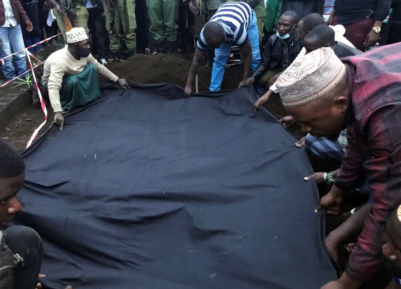 Civilians bury the body of Congolese ranger Burhani Abdou Surumwe who was killed in an ambush in Virunga National Park, a sanctuary for endangered mountain gorillas, in Goma